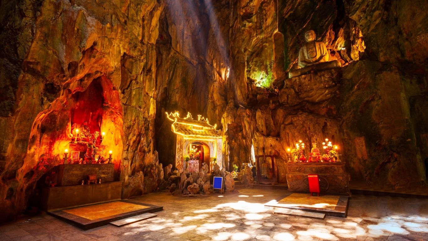 Climb stone steps, explore hidden caves, and admire ancient pagodas at the Marble Mountains