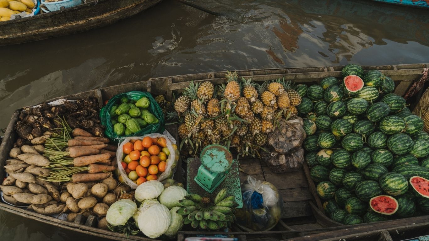 Explore the colorful chaos of the Mekong Delta’s floating markets, where boats brim with fresh produce