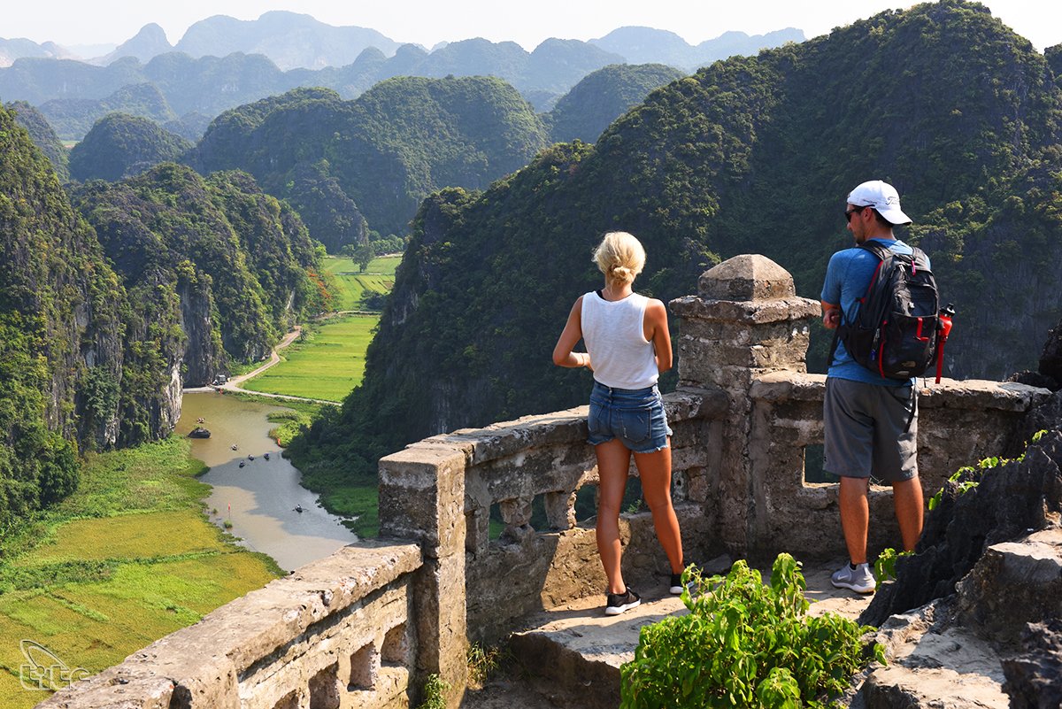 Foreign travelers take in the breathtaking view from the top of Mua Cave in Ninh Binh
