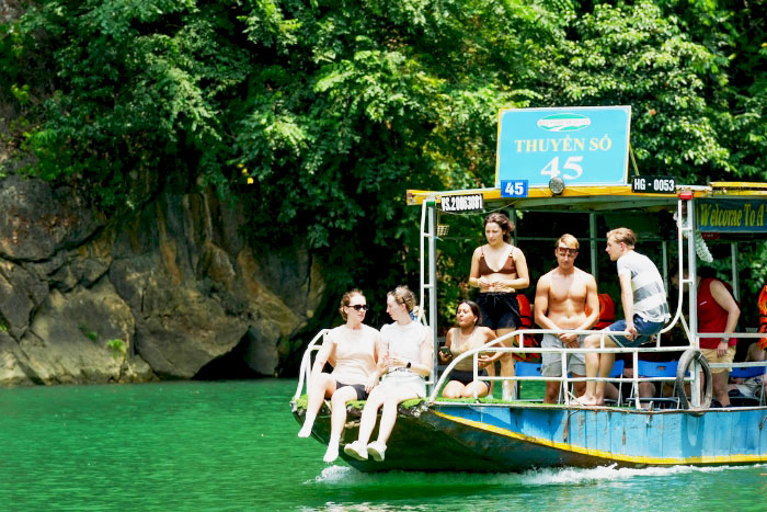 Peaceful boat ride on Nho Que River, surrounded by the cliffs of Vietnam’s deepest canyon