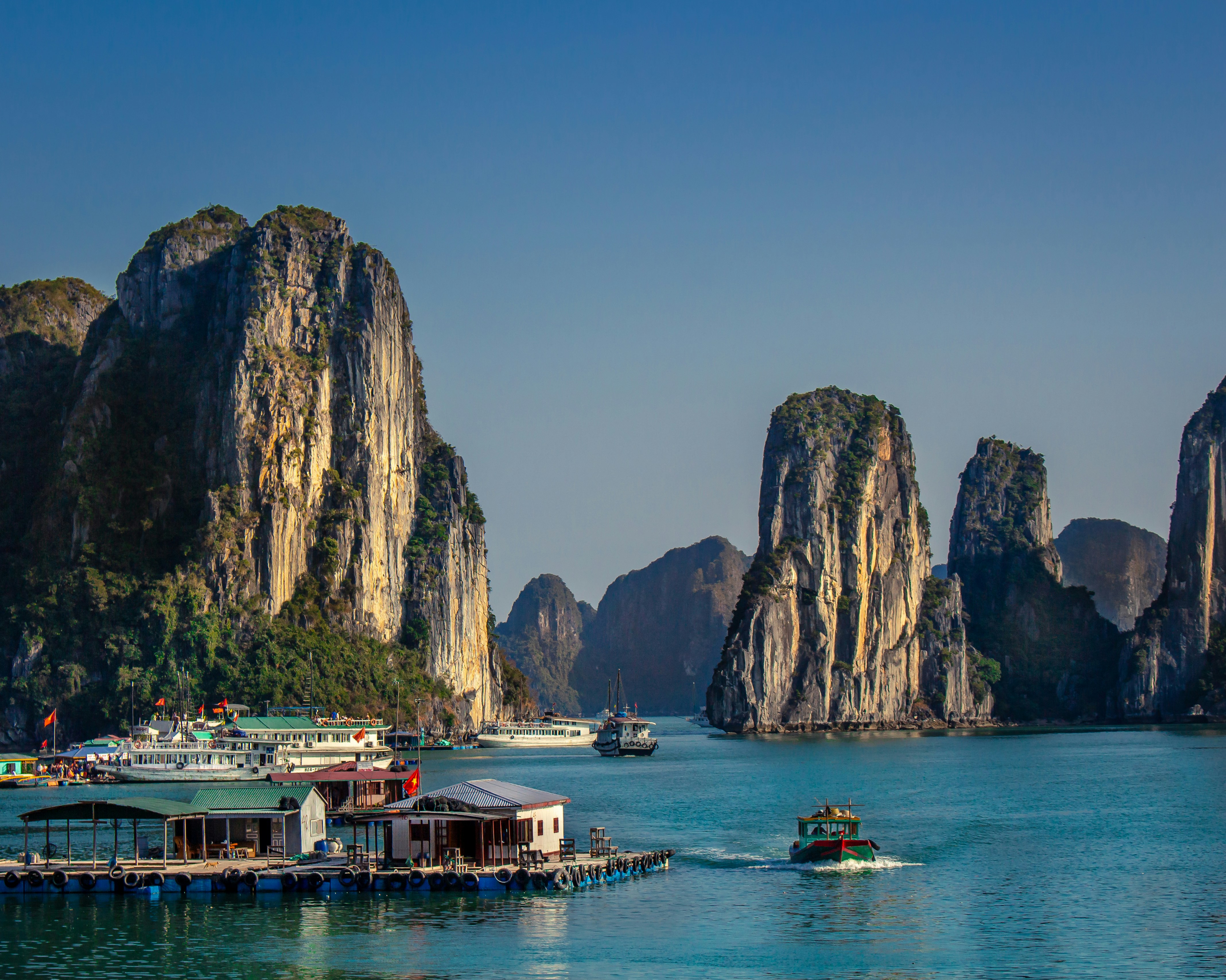 Local life in a floating village surrounded by limestone cliffs in Ha Long Bay