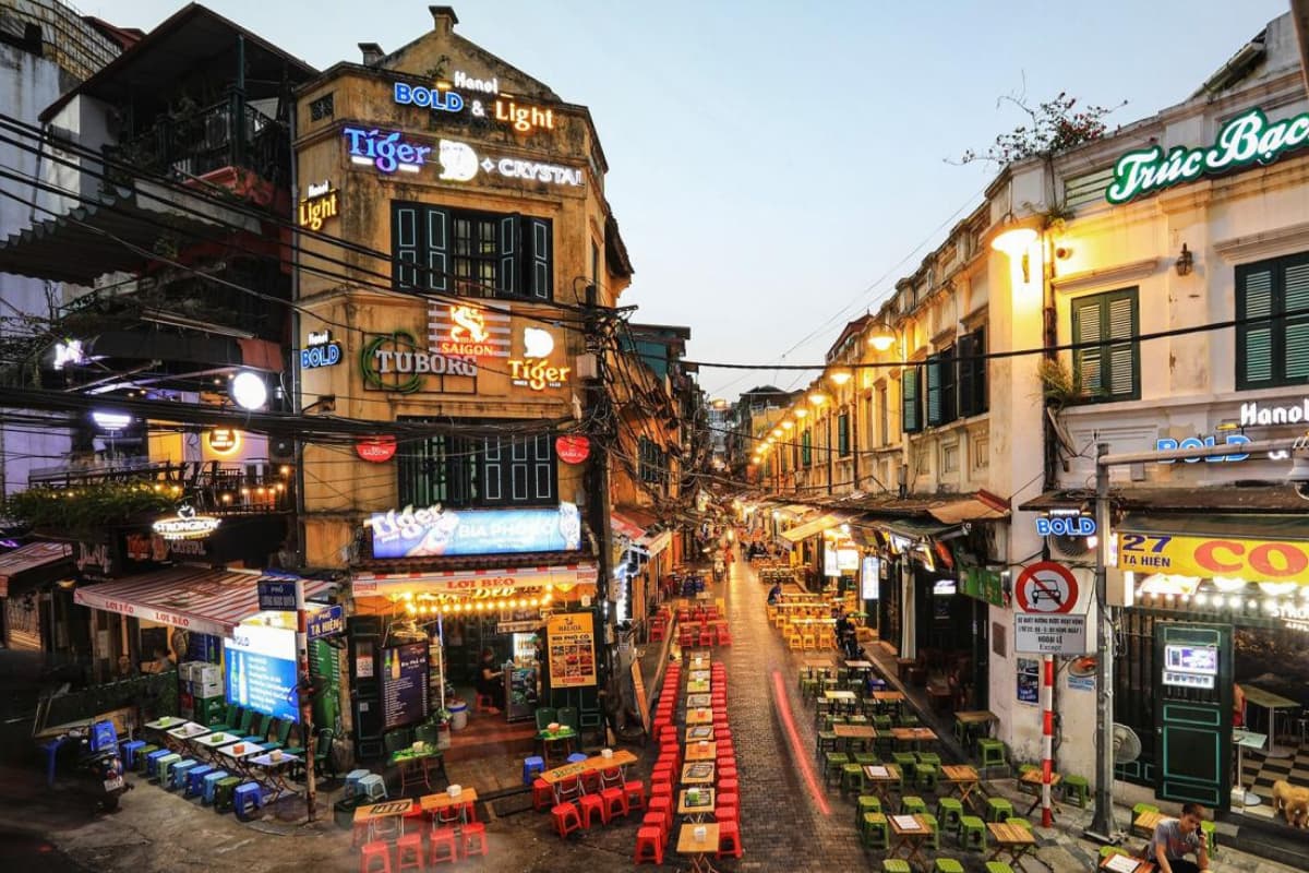 Crowds enjoying street food and local beer on Ta Hien Street in Hanoi Old Quarter at night