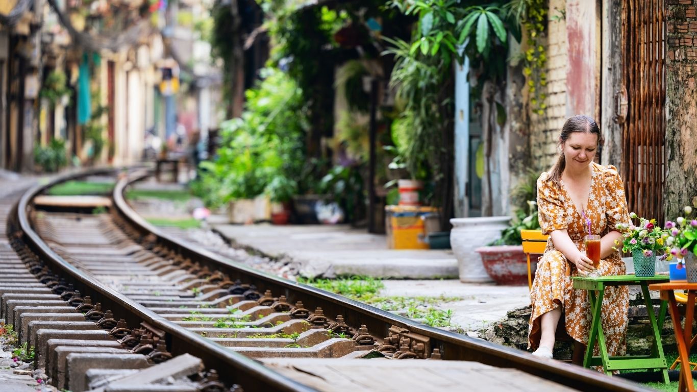 Tourists sitting at cafés along Hanoi Train Street