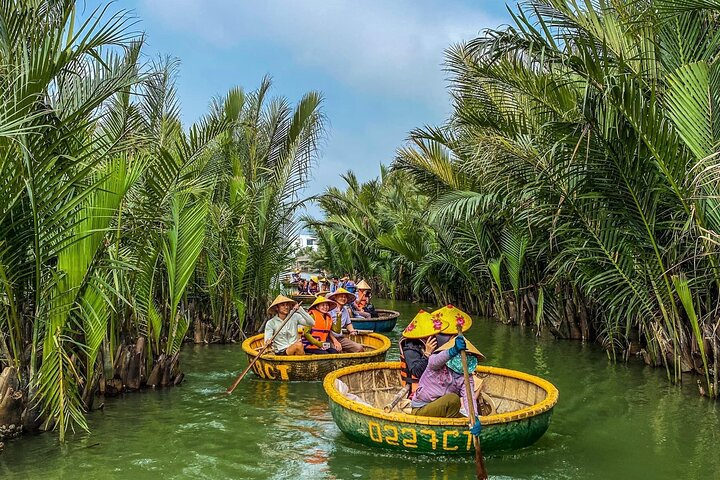 Tourists enjoy a fun ride in Hoi An's iconic basket boats through the coconut forest