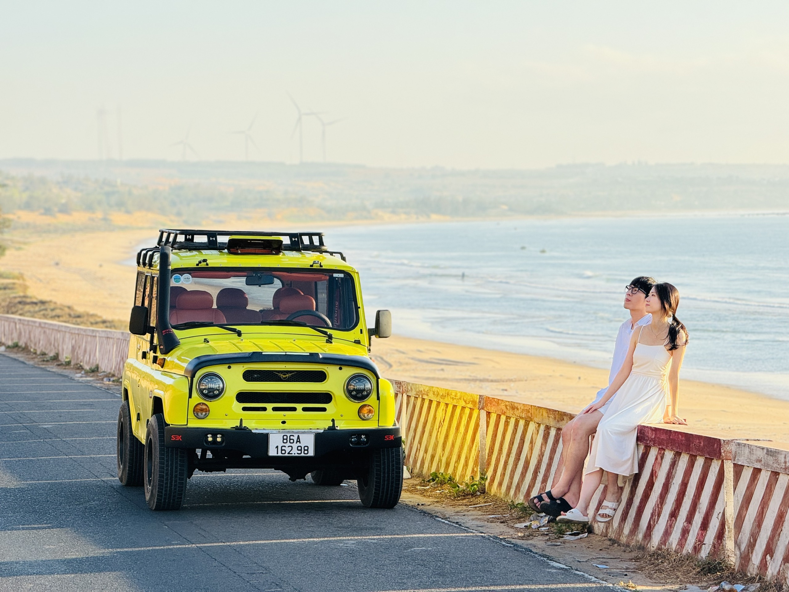Iconic Jeep cruising along the windswept coast of Hon Rom