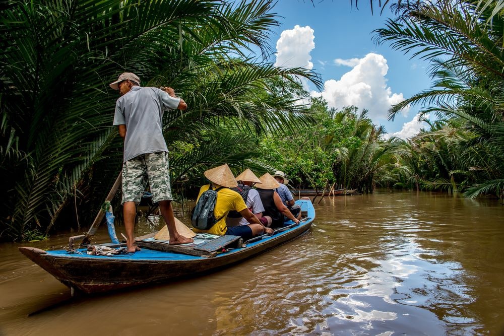 Cruising through peaceful canals on a traditional boat in the Mekong Delta